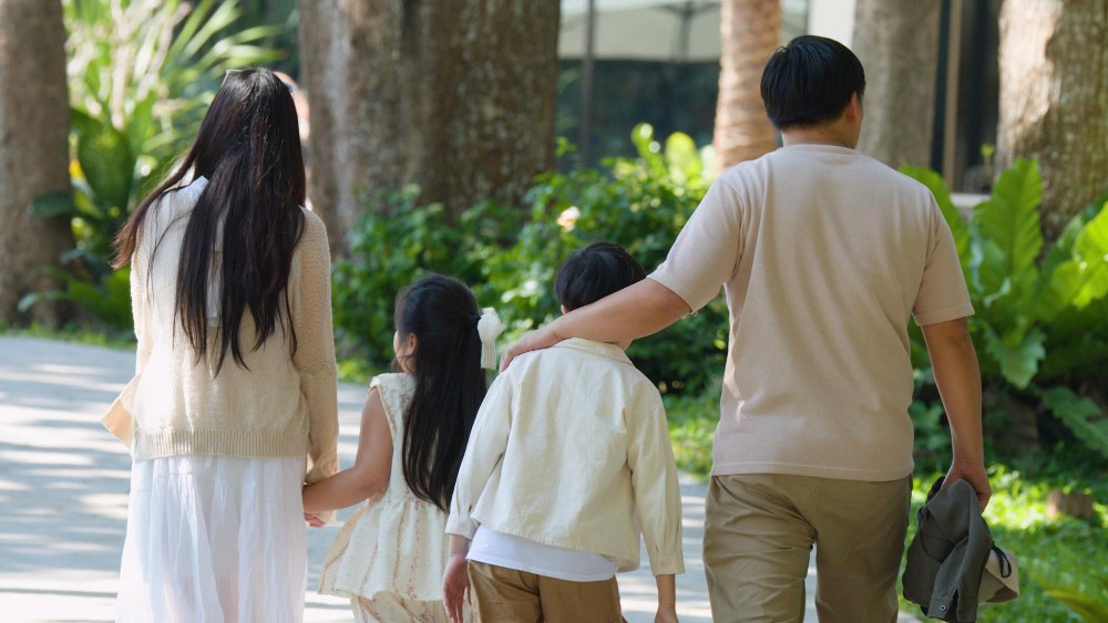 A family walking together in a park as part of a routine that helps manage anxiety