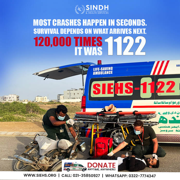 SIEHS 1122 rapid response team treating a road accident casualty beside a life-saving ambulance