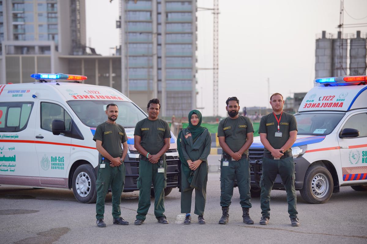 SIEHS 1122 paramedic crew standing with rapid response ambulances in Karachi