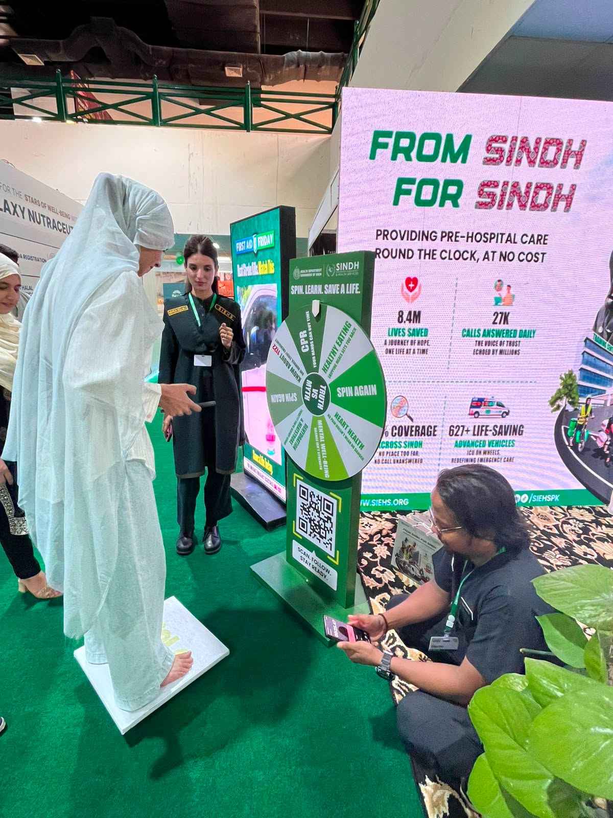 Visitor on the Balance Board beside the Truth vs Myth Spin the Wheel stand at the SIEHS Health Asia 2026 Experience Zone