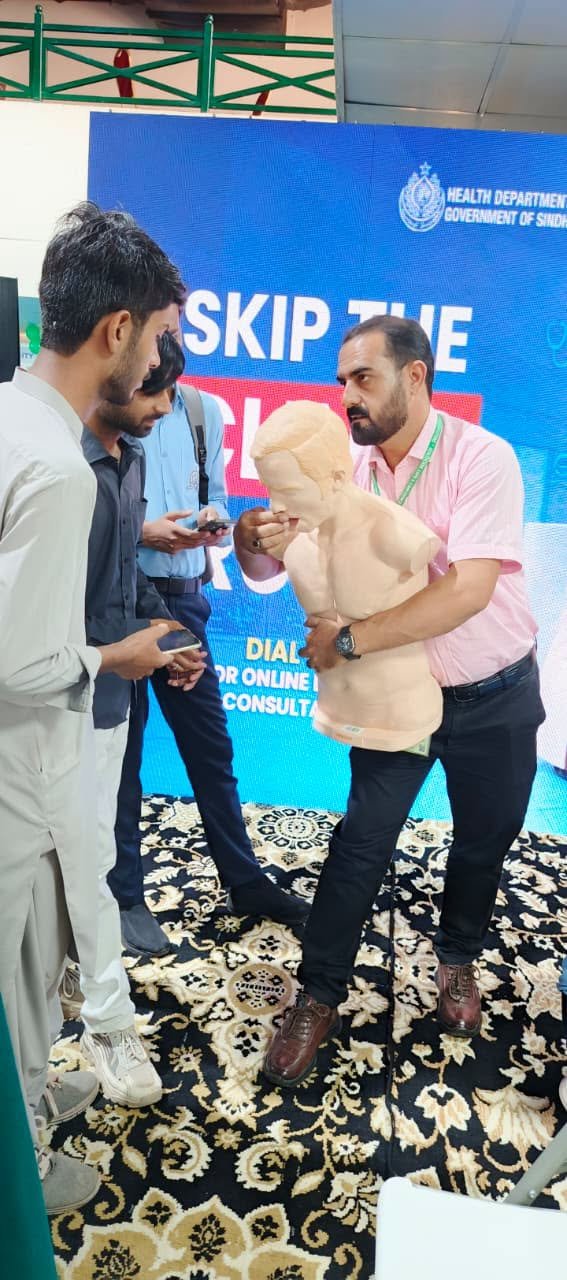 SIEHS instructor demonstrating the choking response manoeuvre on a training manikin at Health Asia 2026
