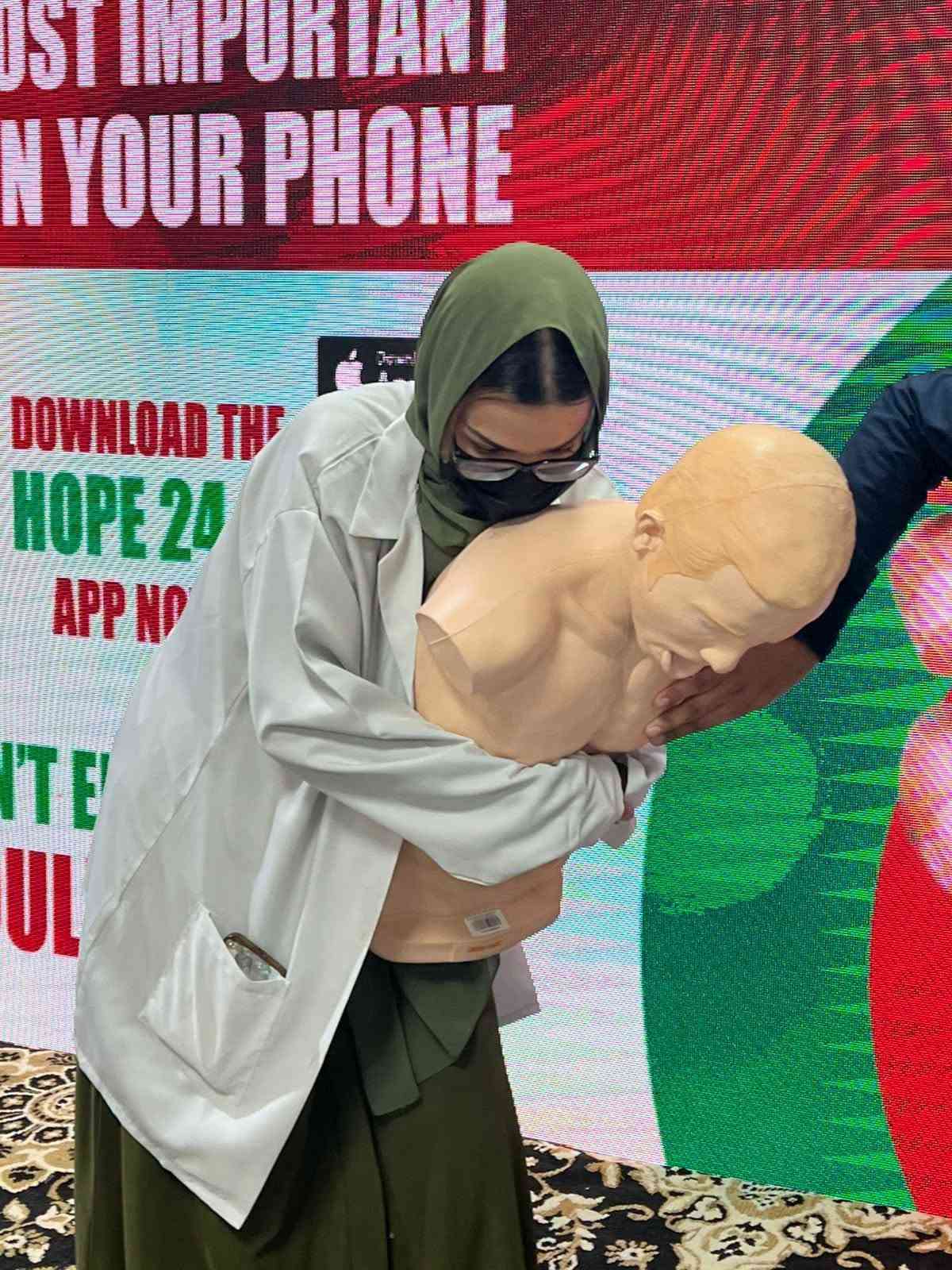 SIEHS instructor demonstrating choking response on a training manikin at Health Asia 2026