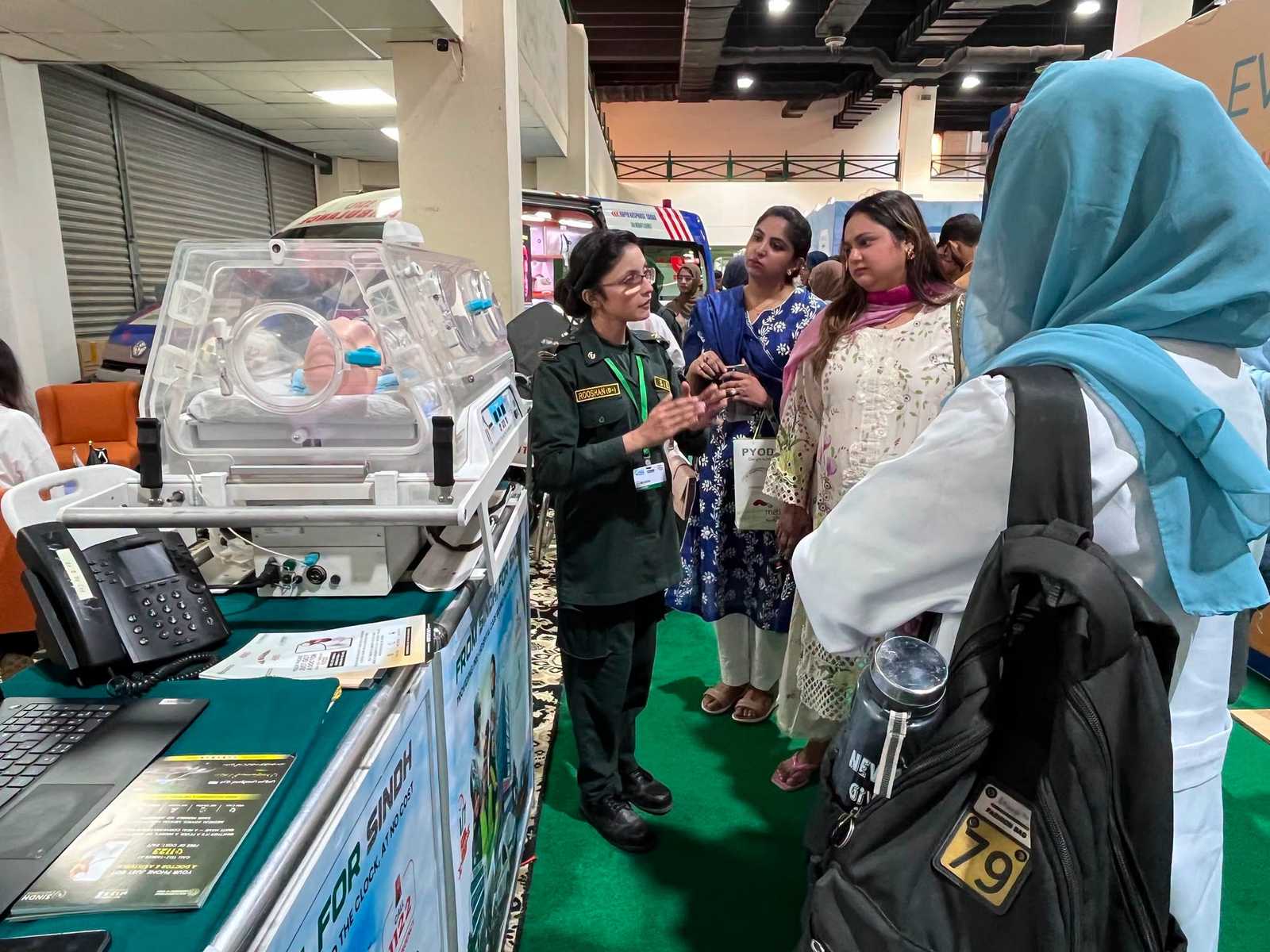 A crowd of visitors viewing the SIEHS neonatal incubator demonstration at Health Asia 2026