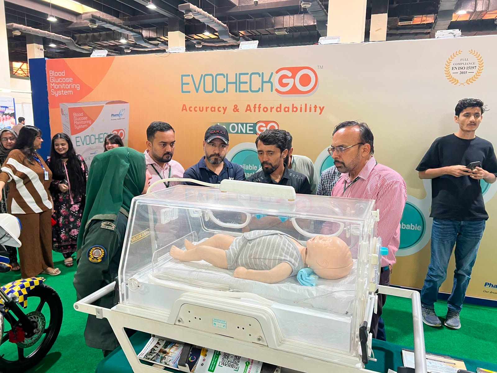 SIEHS emergency medical technician explaining a neonatal incubator display at Health Asia 2026 Karachi