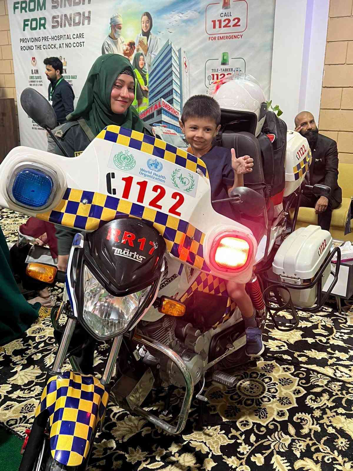 Child sitting on a SIEHS Rapid Response Motorcycle Unit C-1122 at the Health Asia 2026 Experience Zone