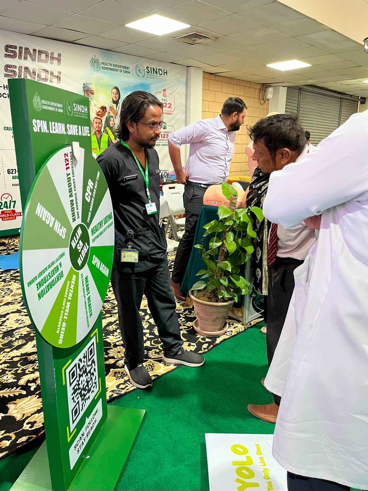 Visitors playing the Spin the Wheel health awareness game at the SIEHS Health Asia 2026 booth