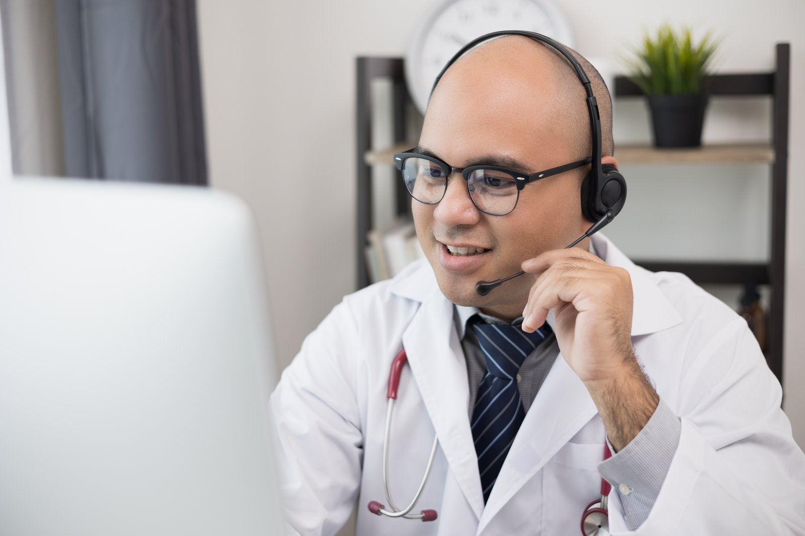 Doctor providing medical advice over the Tele-Tabeeb 1123 telemedicine helpline