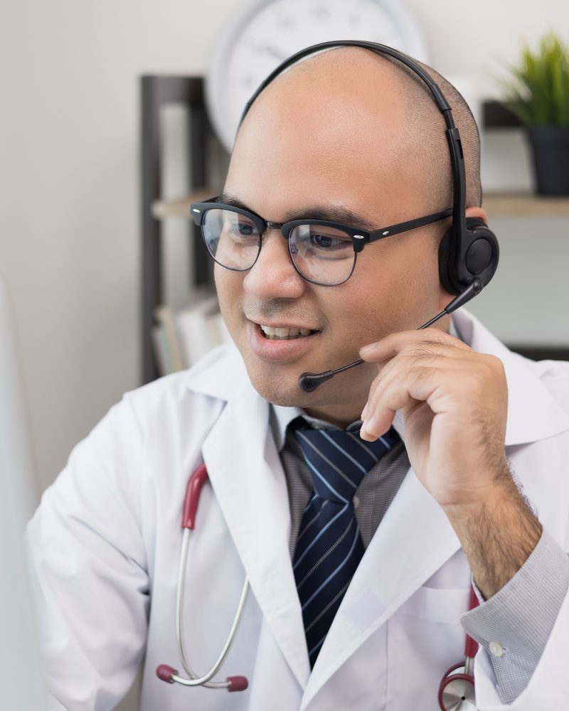 Doctor wearing a headset speaking to a patient on a free doctor consultation call