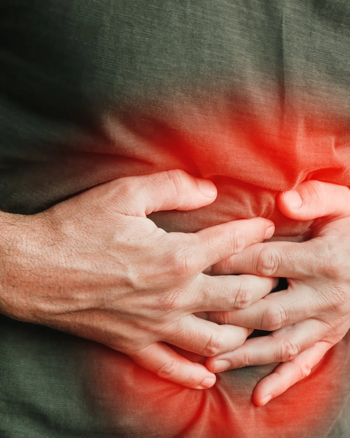 Typhoid stomach pain and abdominal cramps, person holding abdomen in discomfort